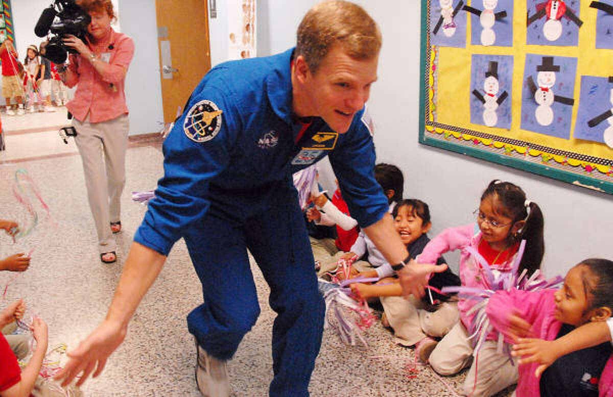 Scott Parazynski greets students at Poe Elementary School in 2007. He presented the a flag he carried aboard his last shuttle flight to the school, where his son Luke is a student.