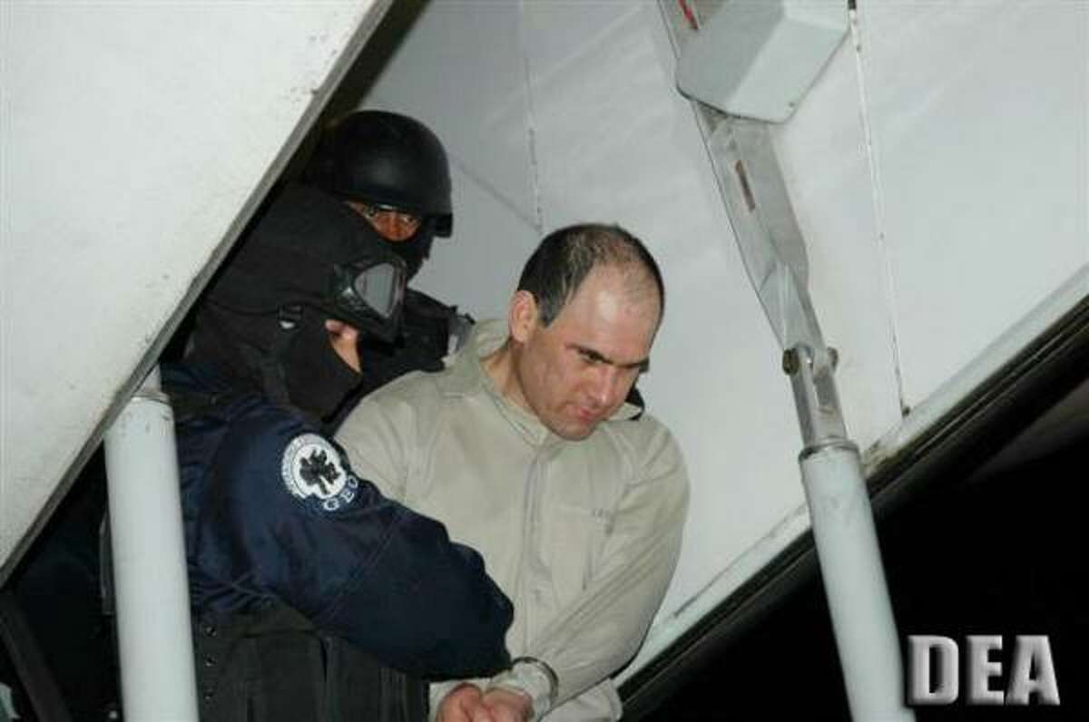 Osiel Cardenas Guillen, who was formerly the reputed principle leader of the Gulf Cartel, is escorted by U.S. federal agents in January 2007, moments after stepping off a Mexican government plane that flew him to Houston to face criminal charges