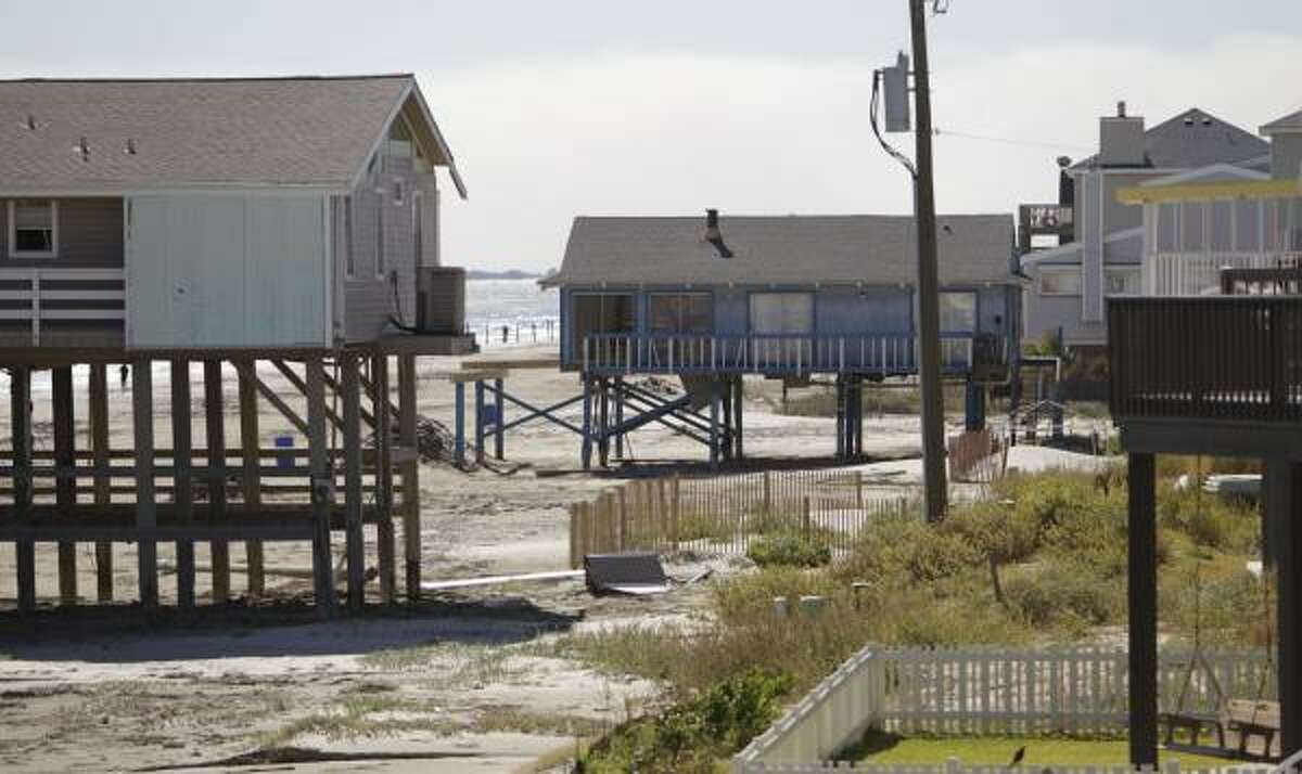 The home at left on west Galveston Island is one of four owned by Carol Severance, who sued the Texas land commissioner over a resanding project and has since sold two of her houses under FEMA’s hazard mitigation acquisition program.