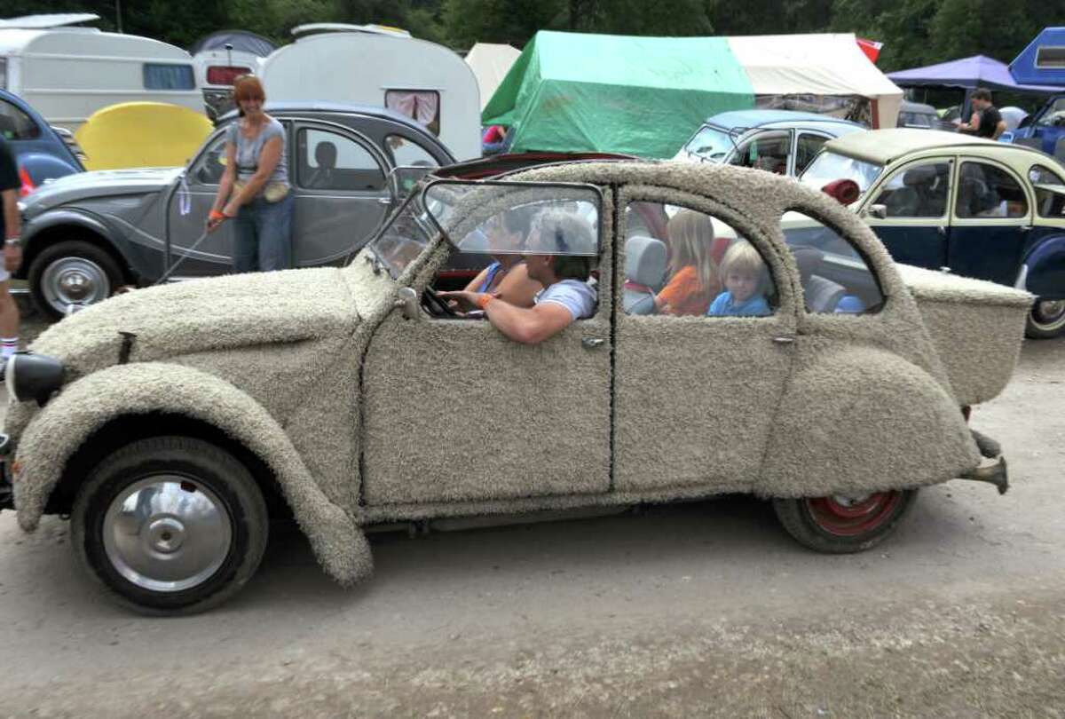 People from the Netherlands drive their customized Citroen 2CV car on July 27, 2011 in Salbris, France during the 19th World meeting of 2 CV Friends.