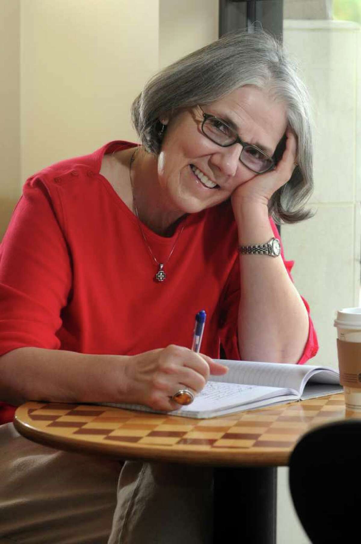 Carolyn Boyd, of The Woodlands, relaxes at Starbucks in the Pinecroft Shopping Center, where she writes most of her poetry. Freelance photo by Jerry Baker