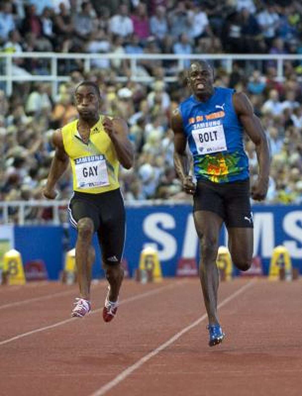 Tyson Gay of the U.S., left, posted a 9.84 en route to victory over the seemingly unbeatable Usain Bolt.
