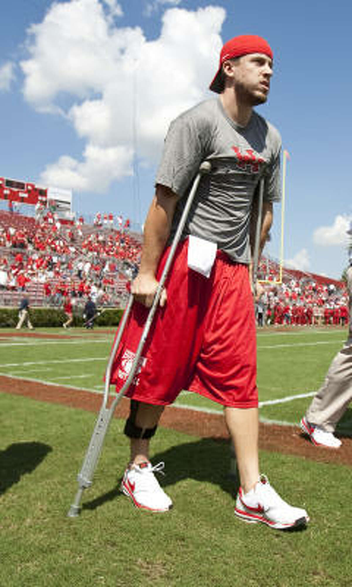 Injured Houston quarterback Case Keenum attends his team's game against Tulane University on Sept. 25.