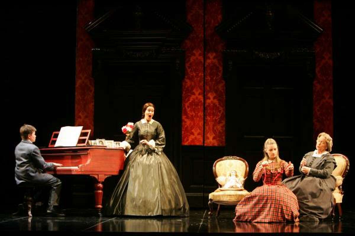 The Governess, her charges Miles and Flora and housekeeper Mrs. Grose are shown in Opera Queensland's 2005 production, one of director Neil Armfield's six previous stagings of The Turn of the Screw. (A different cast stars in HGO's production.)