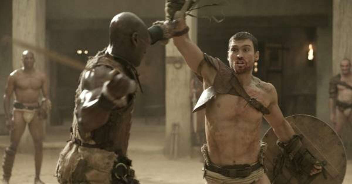 Doctore (Peter Mensah) trains Spartacus (Andy Whitfield) to be a gladiator in Spartacus: Blood and Sand.