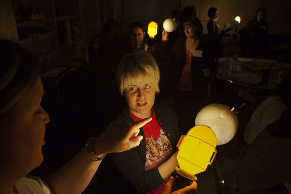 ﻿Angela Lentz, left, and Julie Breedlove﻿ learn how to teach kids about ﻿the Earth's rotation around the sun.﻿