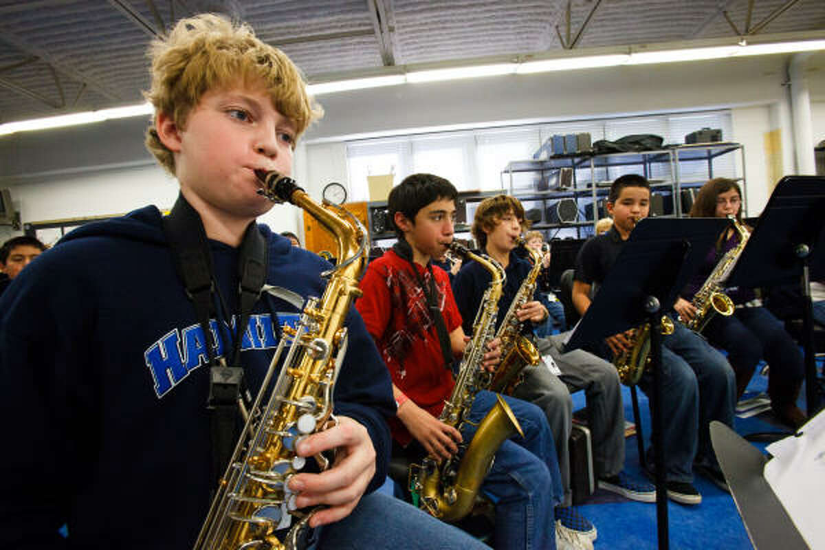 Hamilton Middle School students Benjamin Flannery, left, Stephen Garza, Wes Gil, Brandon Pallares and Victoria Simerskey practice on their alto saxophones.