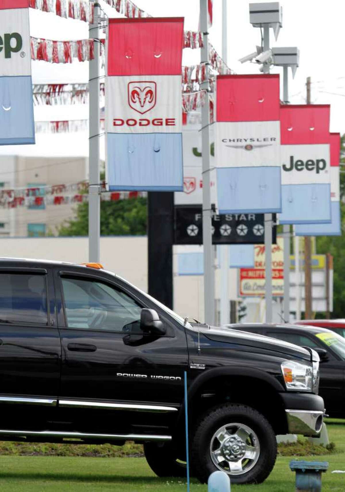In this July 13, 2011 photo, a 2012 Dodge Power Wagon pickup truck is shown at a dealership in Hillsboro, Ore. Chrysler Group LLC said its sales rose 20 percent over last July. It was helped by new products such as the Jeep Grand Cherokee, which saw sales jump 76 percent. (AP Photo/Don Ryan)
