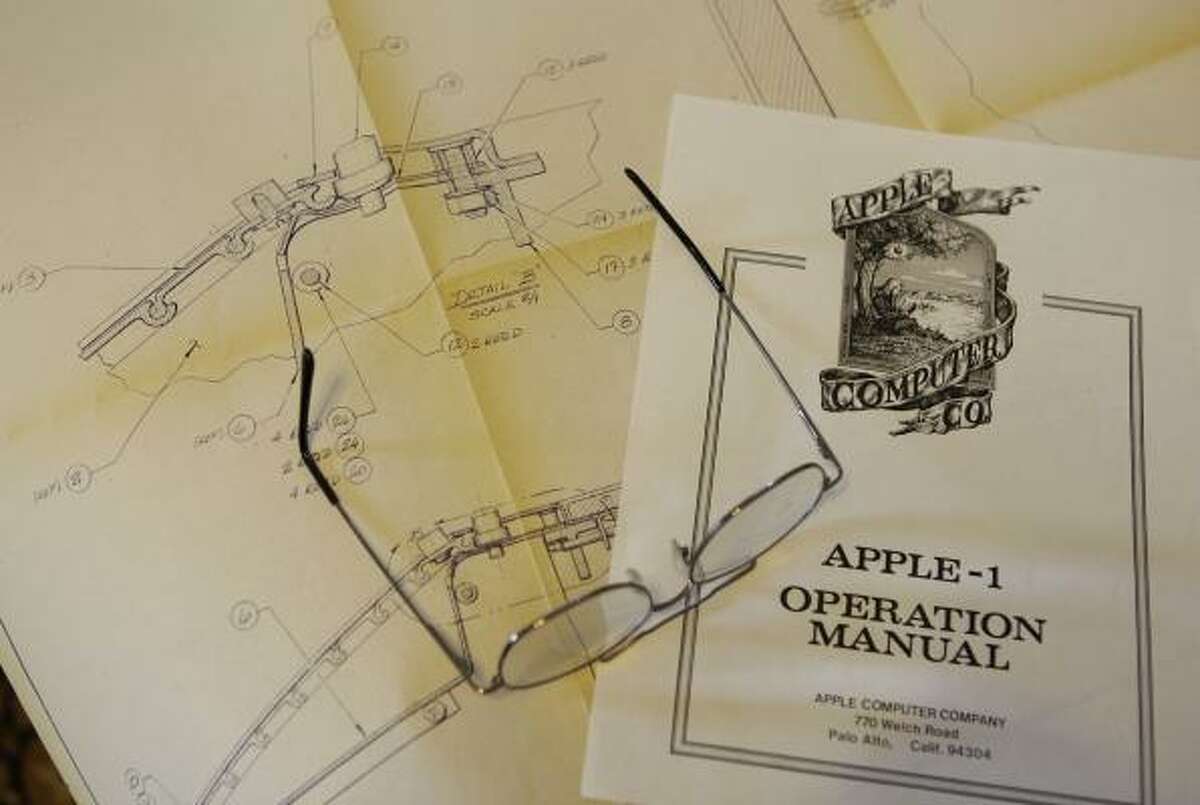 This is a copy of the yellowed blueprint plans for the cabinet for the Apple I and the operation manual that Ron Wayne designed.