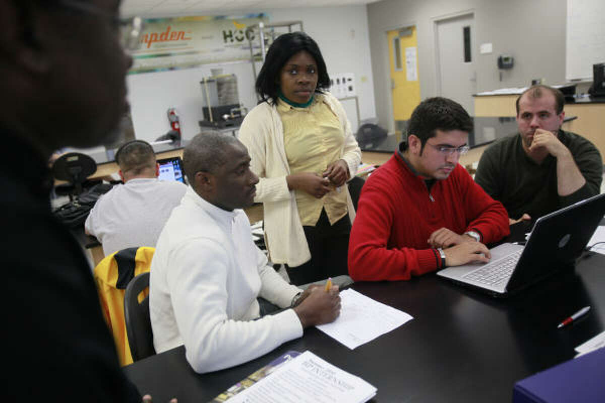 Students, from left, Cheikh Barry, 39, Asenat Onguene, 27, Jose Miguel Fragacha, 29, and Daniel Cranmer, 30, collaborate in their green technology class at Houston Community College.﻿﻿