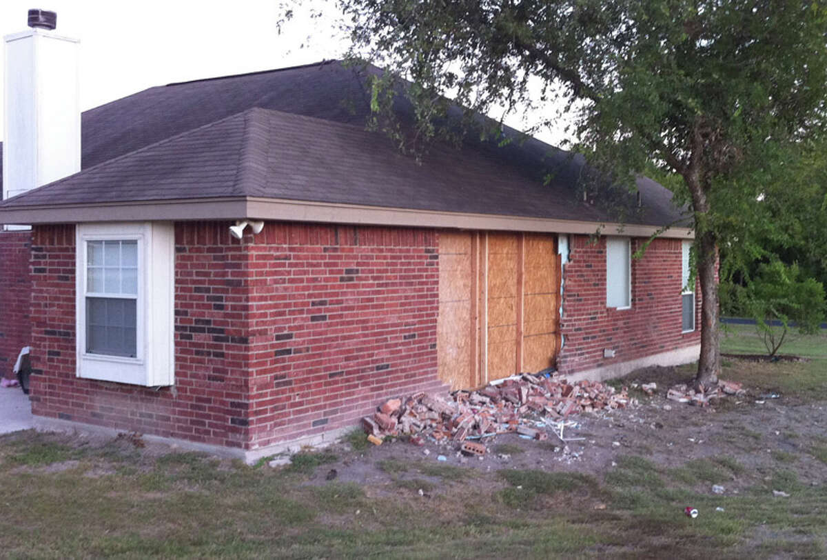 Bricks and car debris littered the outside of a West Bexar County home that a pickup crashed into Monday morning. Residents in the neighborhood say drivers constantly speed on Grosenbacher Road, which the damaged side of the house faces.