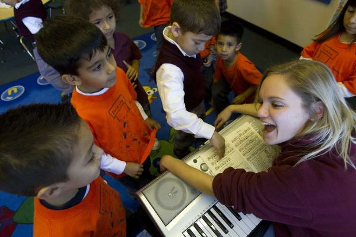 Music teacher Maggie McGrath leads a music class Friday at Our Lady of Guadalupe, which is one of 13 inner-city Catholic schools the Archdiocese is helping.