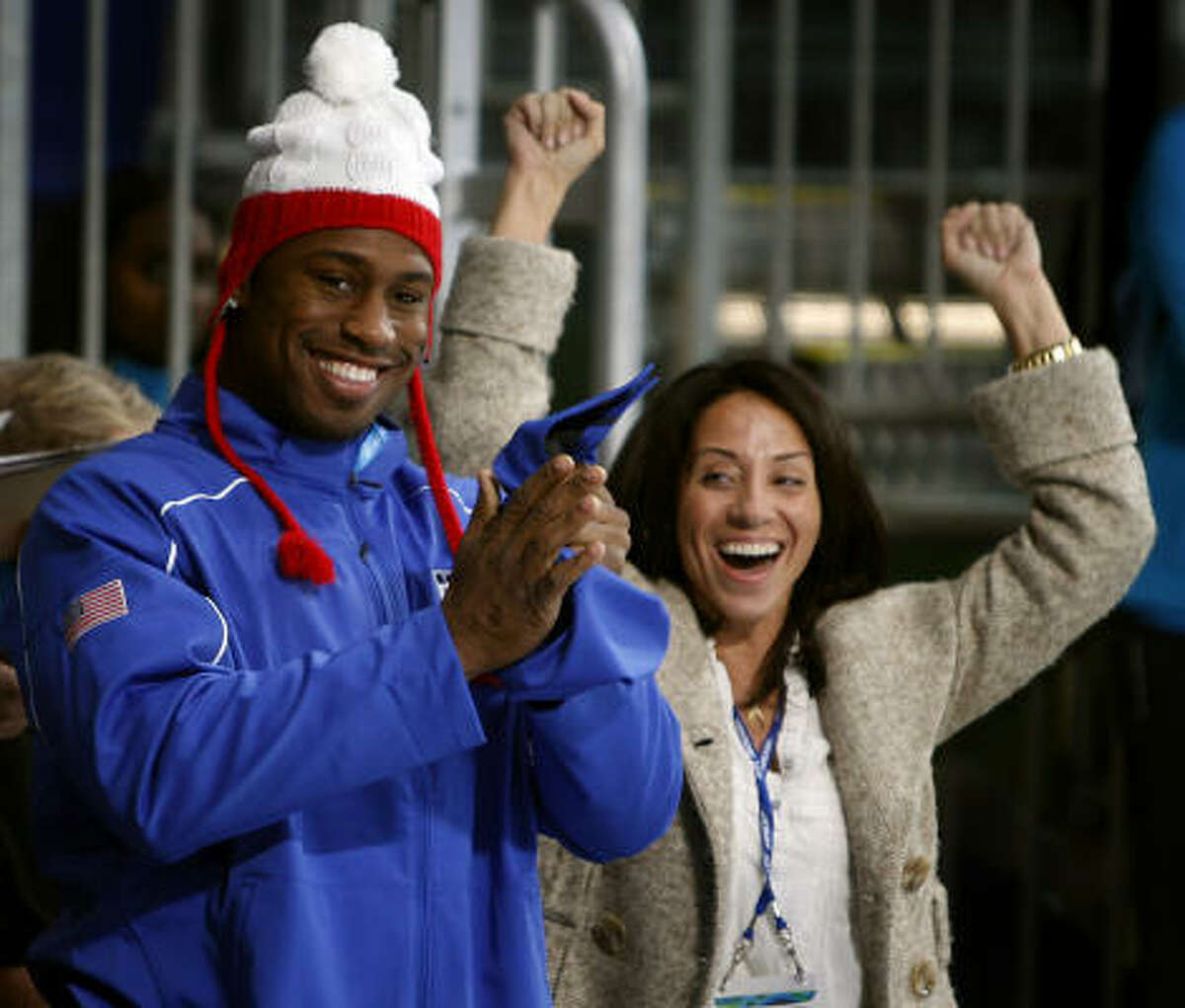 As honorary captain of the U.S. curling team, San Francisco 49ers tight end Vernon Davis, along with his assistant, Sasha Taylor, takes special delight in watching the Americans capture their first victory of the 2010 Winter Games on Friday.