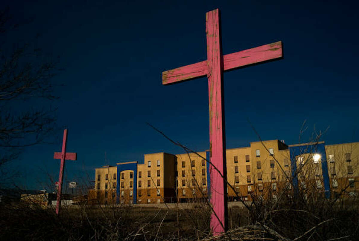 Faded crosses mark where Irma Monreal's daughter, Esmeralda, and seven other women were found dead in a cotton field in Ciudad Juarez.