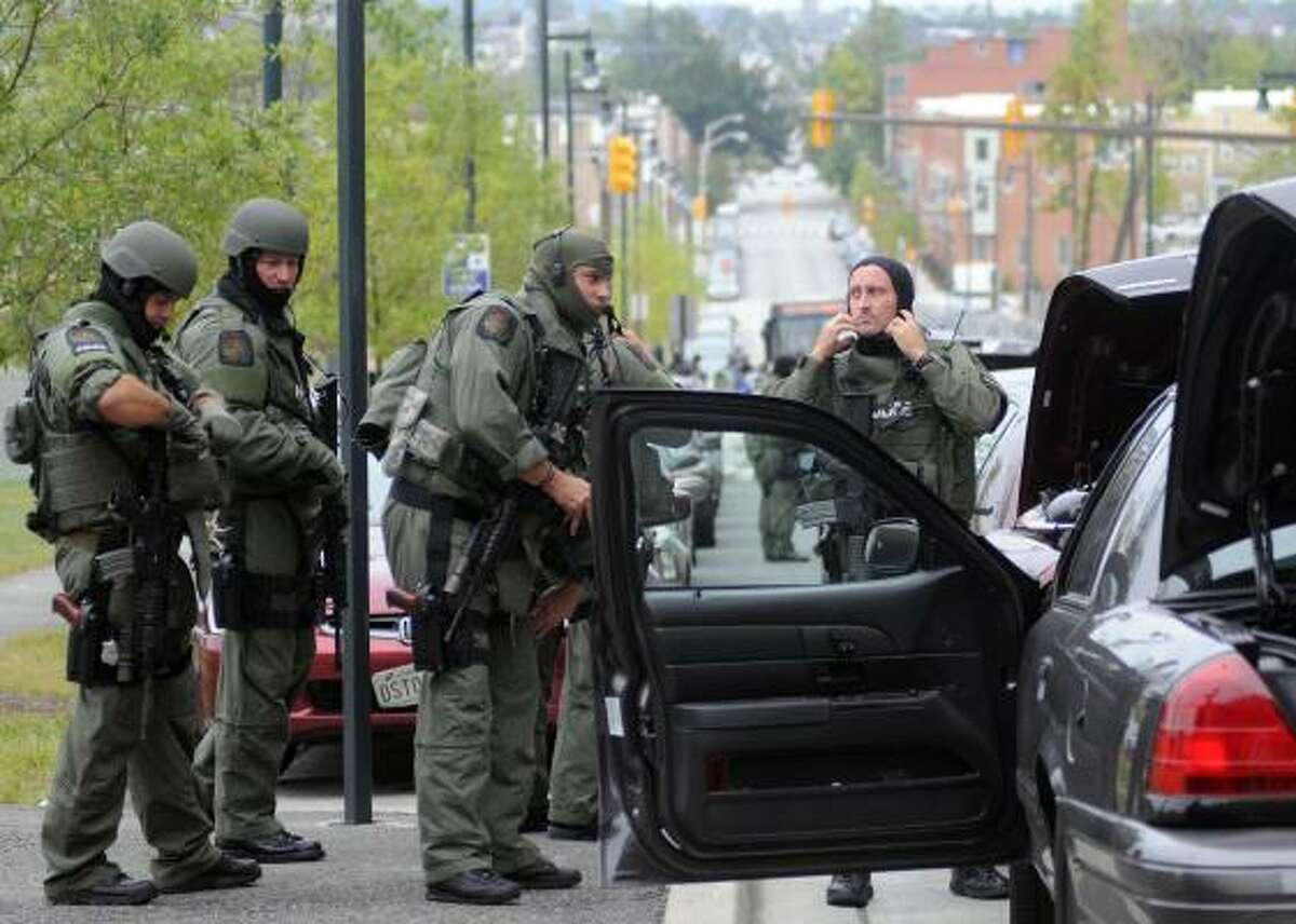 Members of the Baltimore County SWAT team arrive at Johns Hopkins Hospital in Baltimore after a man shot and wounded a doctor on Thursday.