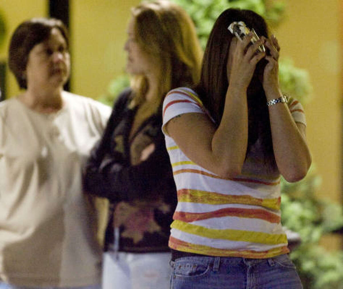Micalet Kemp, right, throws her hands up in an act of emotion,Thursday April 22, 2010. At the Crowne Plaza hotel in Kenner La. knowing her loved one is still missing in the aftermath of the Deepwater Horizon oil rig explosion.