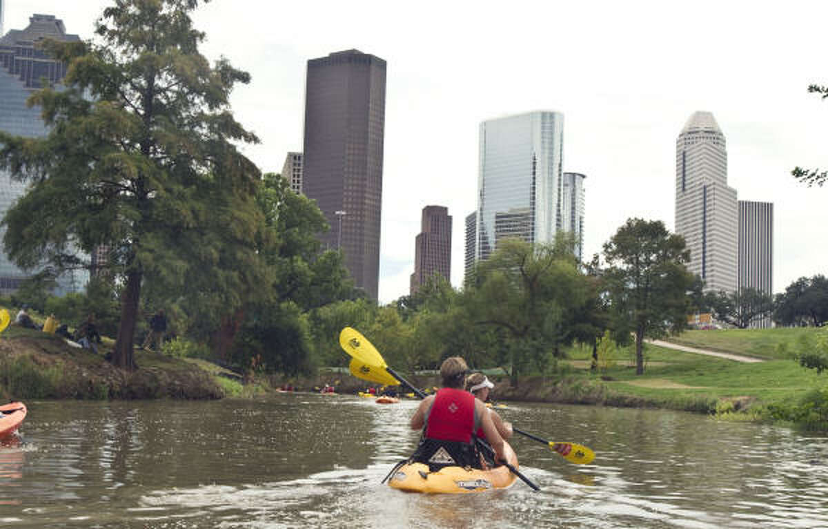 GO WITH THE FLOW: Kayakers paddle Buffalo Bayou on Buffalo Bayou Shuttle Service's Skyline Tour.