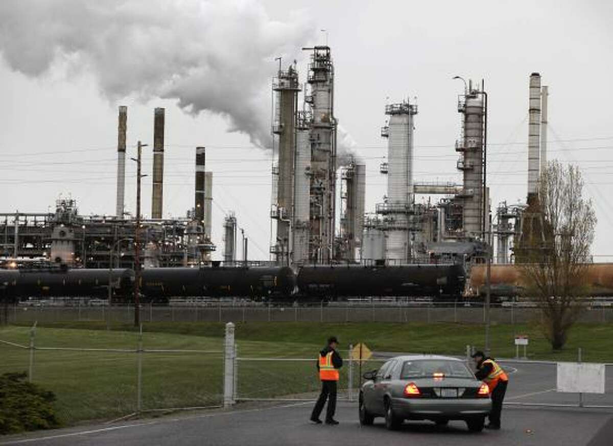 Guards stand by at the Tesoro Corp. plant in Anacortes, Wash.