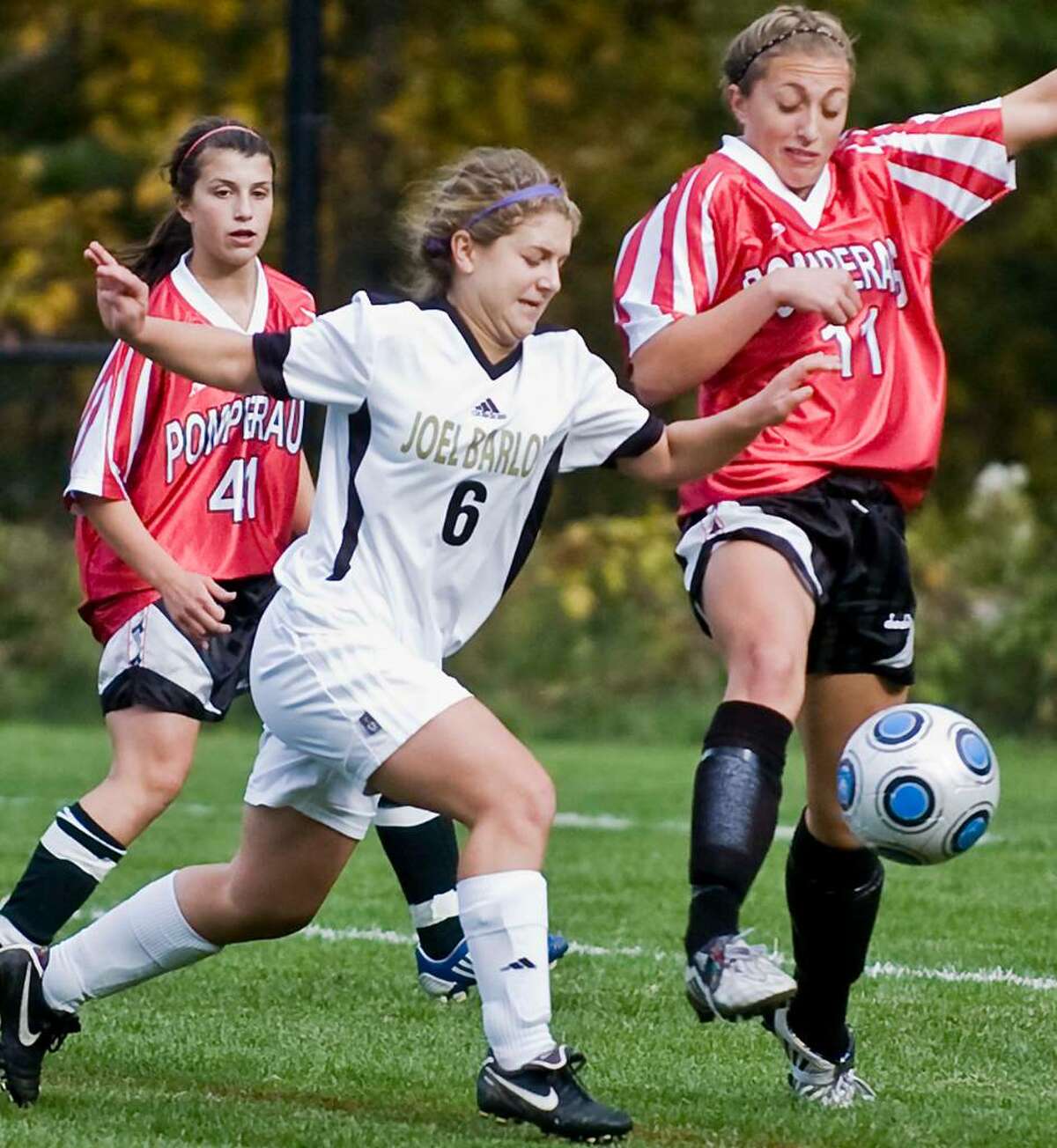Barlow junior Delaney Bracken and Pomperaug senior Lauren Varholak try and get possession of the ball in a girls soccer game at Barlow. Monday, Oct. 5, 2009