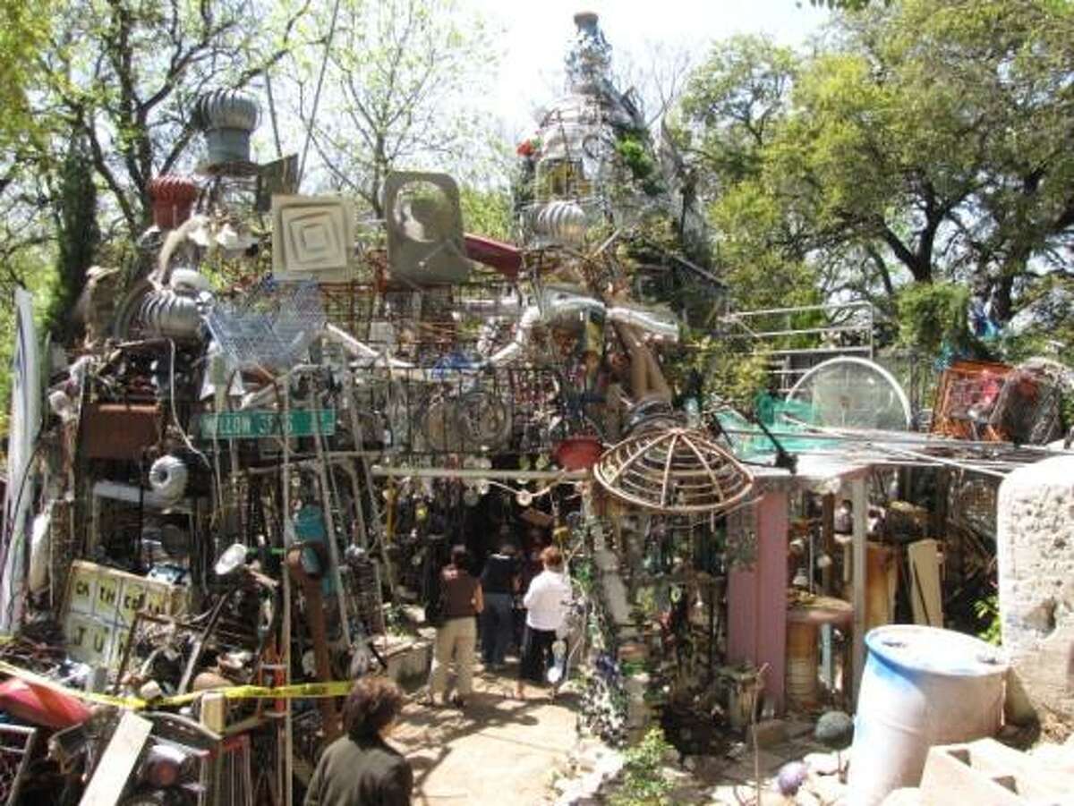 Visitors wander the hallways of the Cathedral of Junk in Vince Hannemann's backyard in Austin. His structure has taken shape over 20 years, but the public is no longer allowed in,