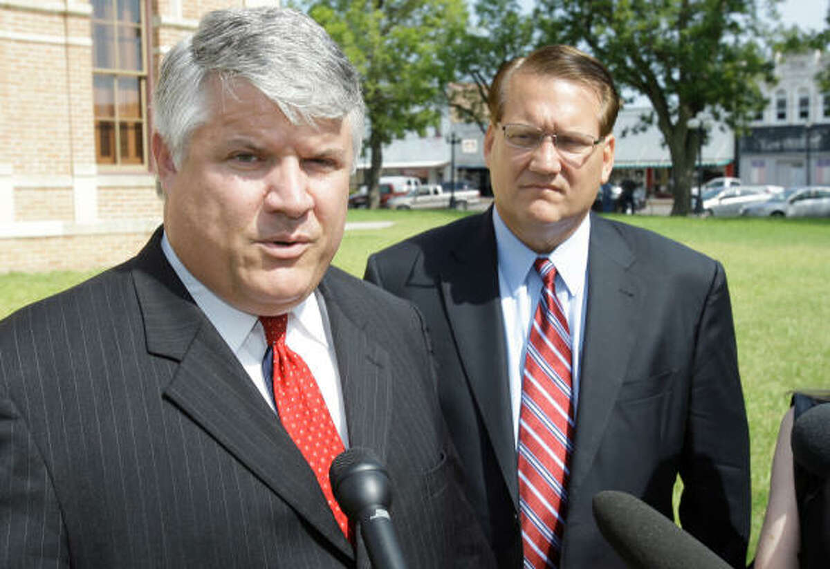 Edward Burwell, left, and Frank E. Mann III, who represent the mother of fallen Wharton firefighter Thomas Araguz III's two children, talk Monday about the court hearing. ﻿