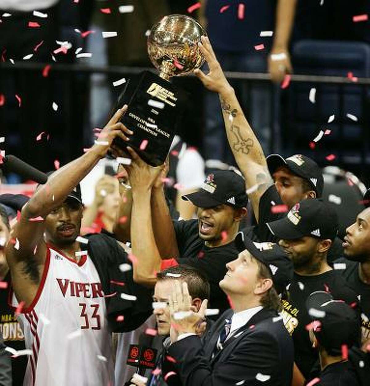 Mike Harris along with head coach Chris Finch and teammates hoist the NBADL League trophy after defeating the Tulsa 66'ers in Game 2 on Tuesday.