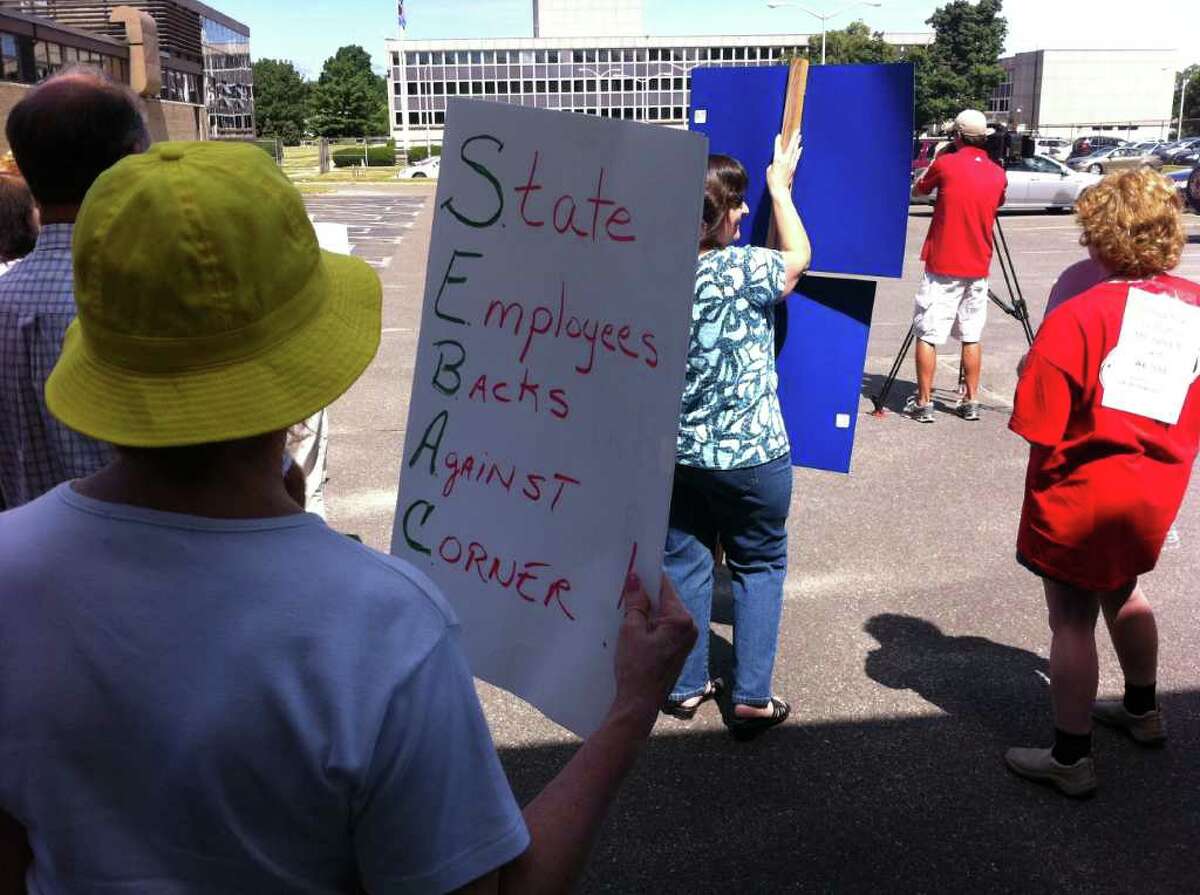 Union workers protest Wednesday outside a hearing by state Board of Labor Relations in Wethersfield. A prosecutor filed a complaint with the labor board claiming that the State Employees Bargaining Agent Coalition overstepped its negotiating authority in the recent tentative agreement on $1.6 billion in concessions. About 50 protestors supported the complaint against the revote.