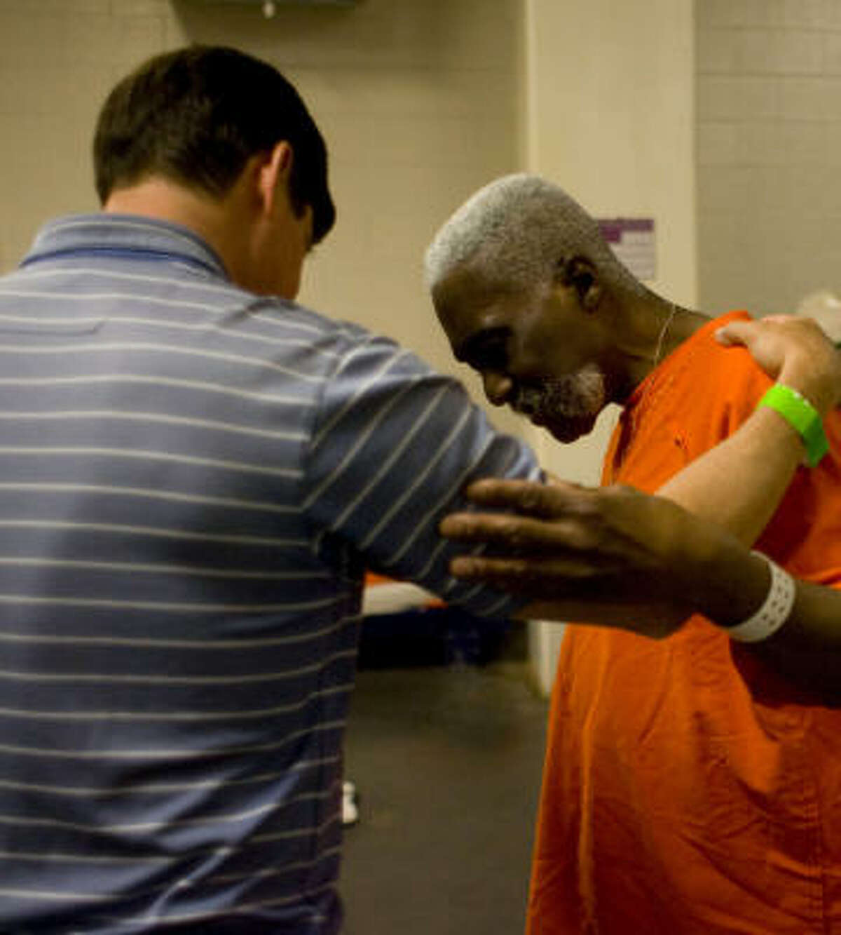 Bill Deloache Jr., one of some 300 Christian volunteers with the Pro-Claim prison ministry, prays with Donald Odom, 55, an inmate at the Harris County Jail on 1200 Baker in Houston.