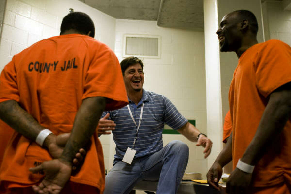 The surroundings can be grim inside Harris County's jail facilities, but Spring chiropractor Bill DeLoache Jr. manages to find some humor to share with inmate Dequan Huffman, right, during this weekend's two-day outreach event.
