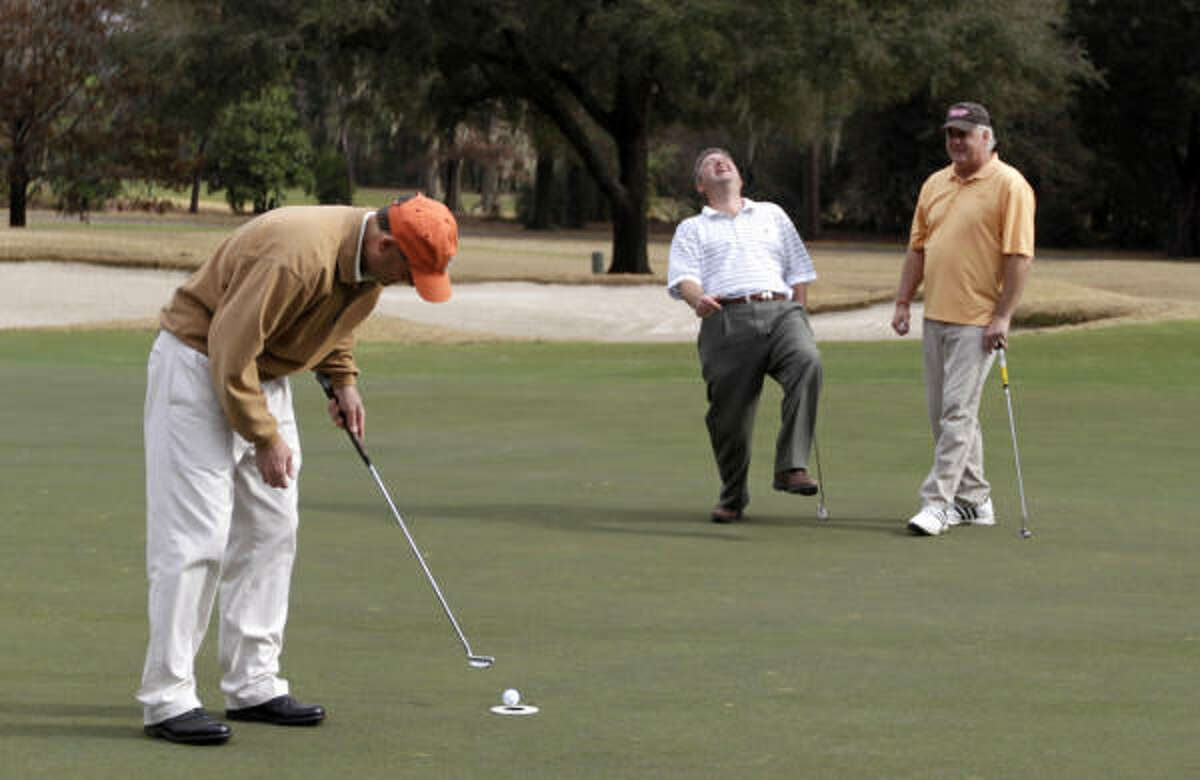 Dec. 30 Craig Phillips laughs as Thomas Ross misses his putt (because the hole was made smaller) on the 18th hole of the Cypress Creek Course during the Champions Golf Club's Rhubarb event on Thursday. Over the years, the event, which pits one half of the locker room against the other in a tournament for bragging rights, has attracted stars such as Steve Elkington, who was unable to attend this year.