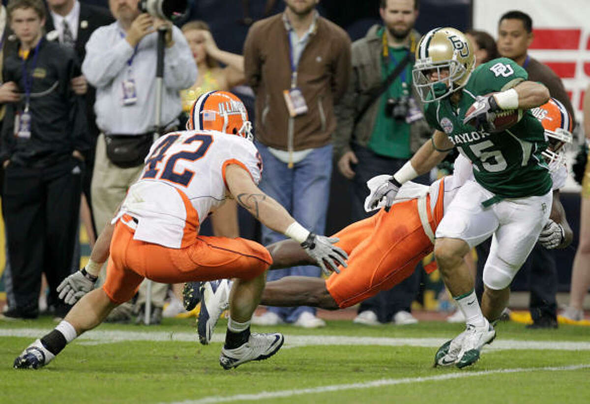 Dec. 29: Illinois 38, Baylor 14 Baylor's Krys Buerck, right, attempts to out-run Illinois' Aaron Gress (42) during Wednesday's Texas Bowl at Reliant Stadium.