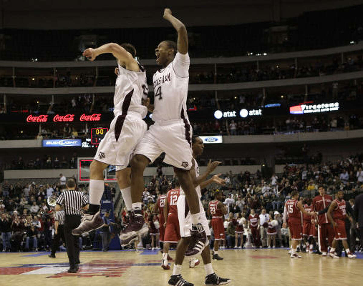 Texas A&M 71, Arkansas 62 (OT) Texas A&M's Nathan Walkup, left, and Keith Davis celebrate following their 71-62 overtime win.