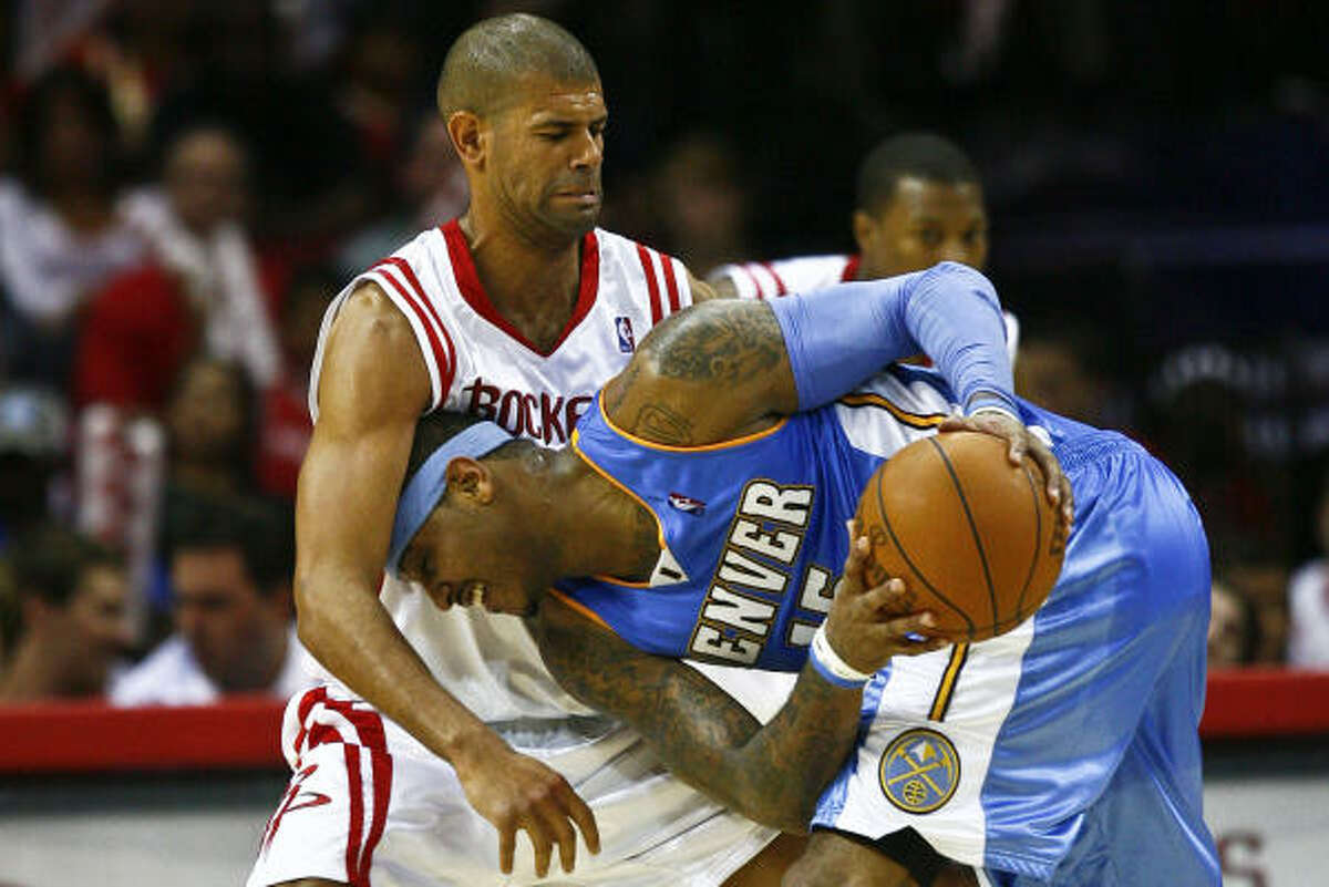 The Rockets' Shane Battier defends against Nuggets forward Carmelo Anthony.