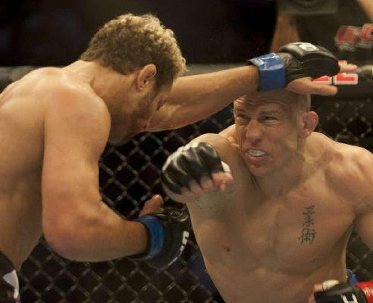 George St-Pierre, right, lands a right to the chin of Josh Koscheck during their welterweight title bout at UFC 124 on Saturday in Montreal. The mixed martial arts fight went the distance, with St-Pierre winning 50-45 on all three judges' card.