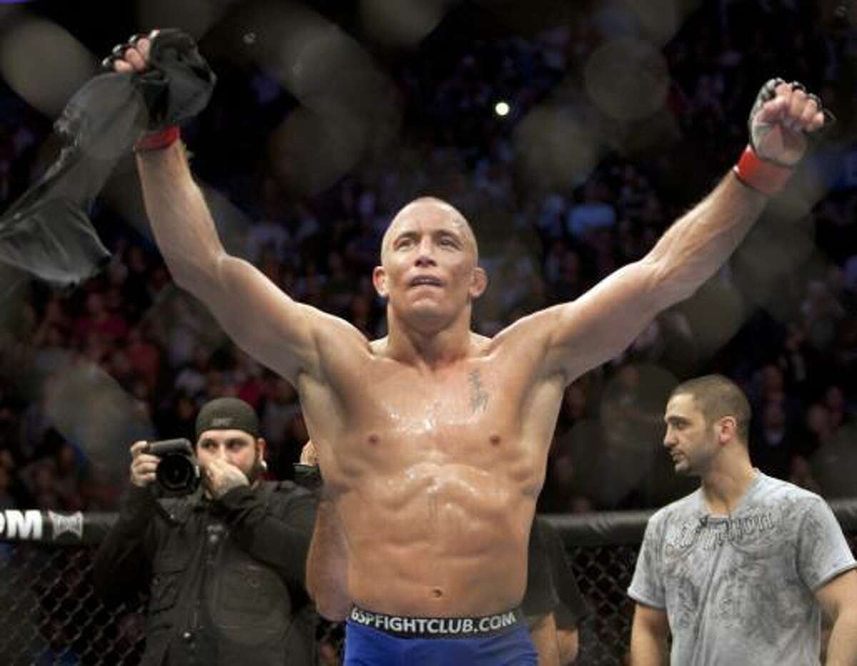 Georges St-Pierre celebrates after defeating Josh Koscheck in a unanimous decision to retain his welterweight title.