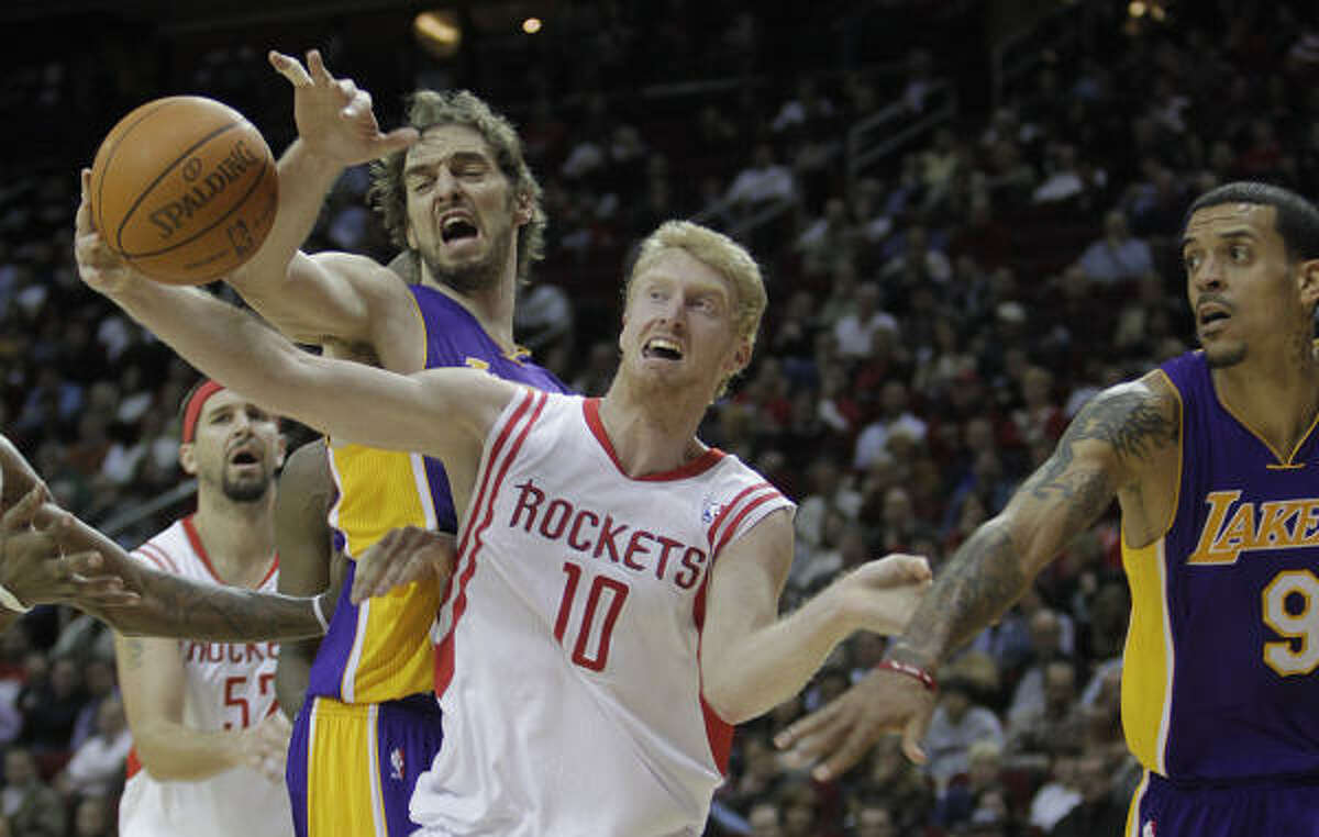 Rockets forward Chase Budinger (10) battles with Lakers forwards Pau Gasol, left, and Matt Barnes for a ball in the second half.