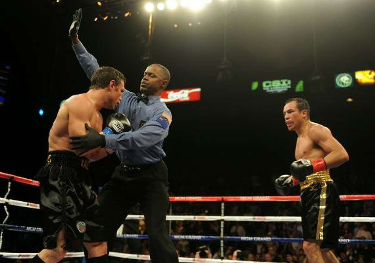 Juan Manuel Marquez watches referee Kenny Bayless end the fight after Marquez wobbled Katsidis with a series of powerful punches.