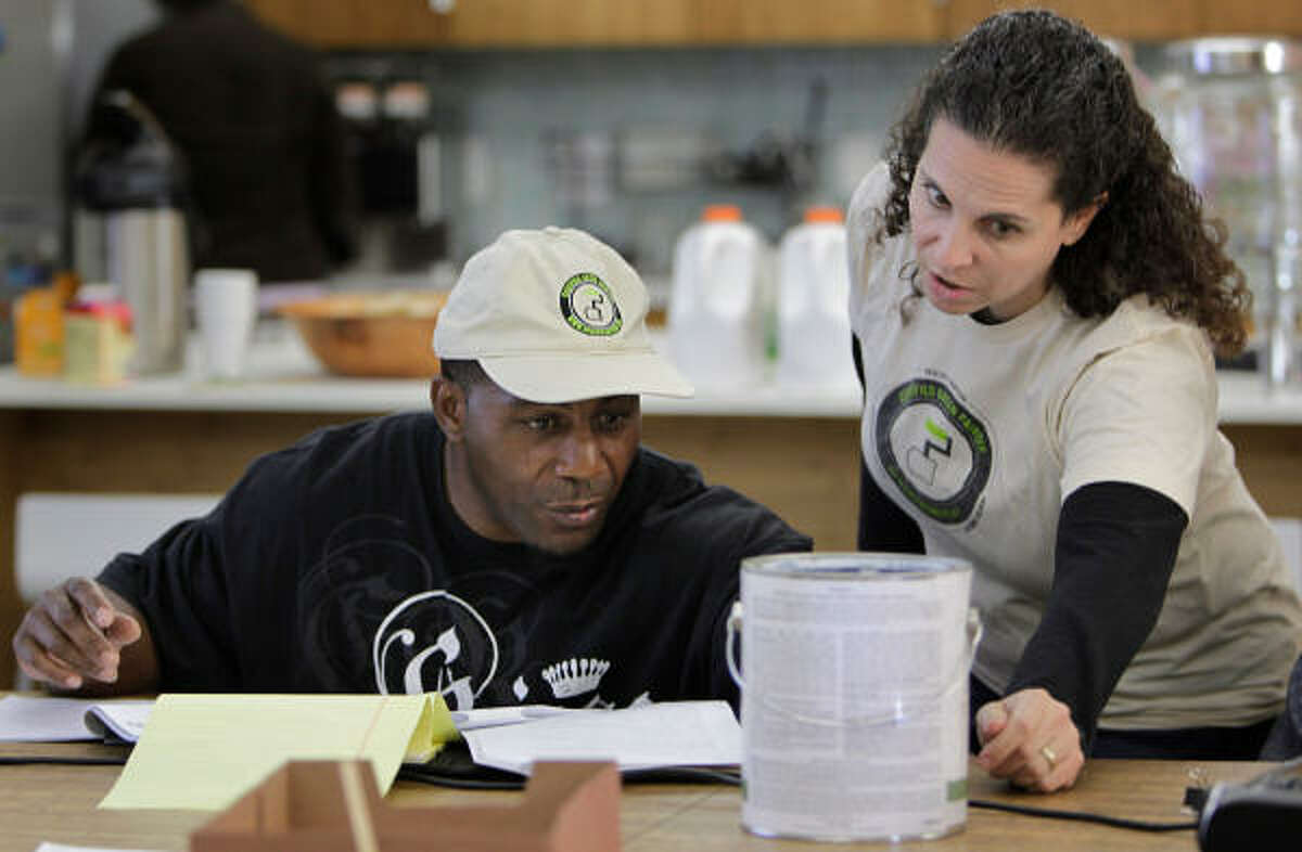 John Smith, an independent contractor, and Jennifer Touchet, a partner with Rice Village building materials store New Living and instructor, discuss chemicals in paint during a green painter certification class at the store.