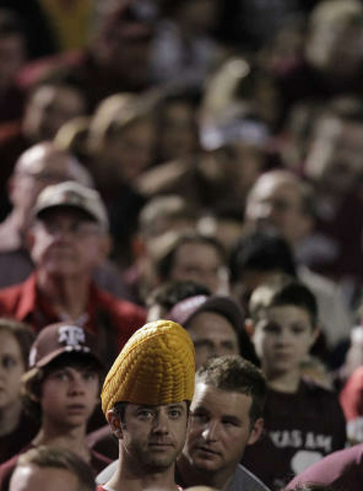 A lone Nebraska fan sits in a sea of A&M fans before the start of the game.