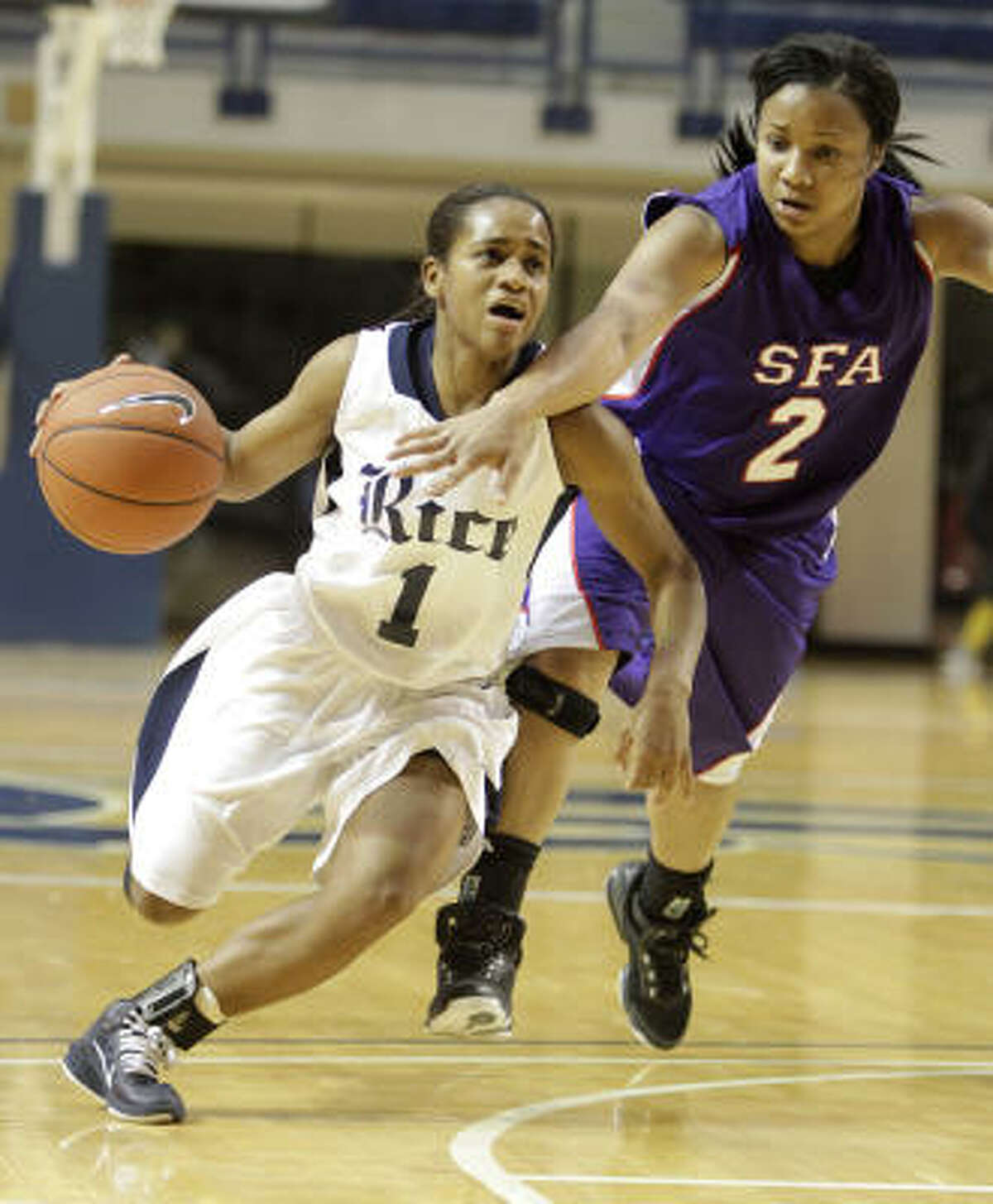 Rice's D'Frantz Smart (1) runs up the court against SFA's Courtney Conwright.