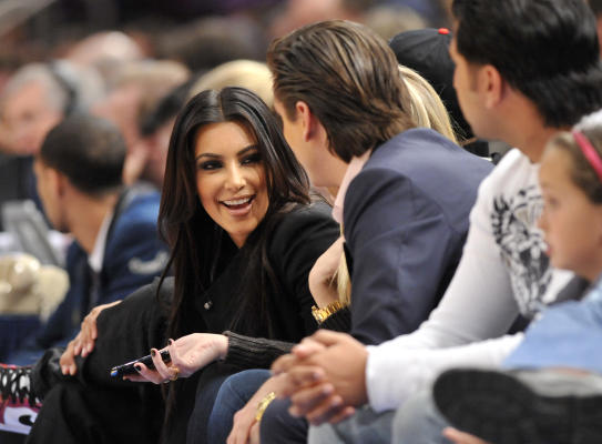 Kylie Jenner, left, and Travis Scott walks to their seats during the second  half in Game 2 of a first-round NBA basketball playoff series between the  Houston Rockets and the Minnesota Timberwolves