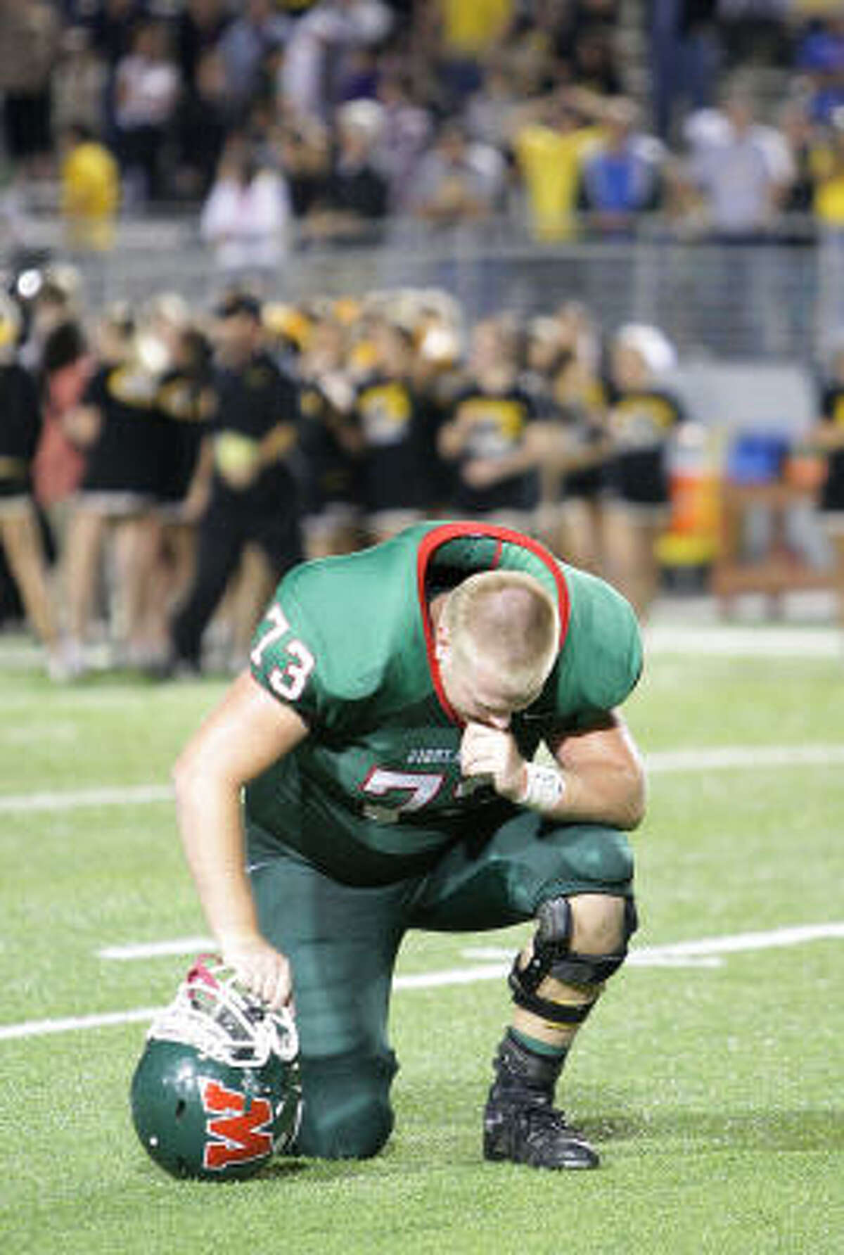 The Woodlands Stephen Carr (73) takes a moment on the field after The Woodlands lost to Klein Oak.