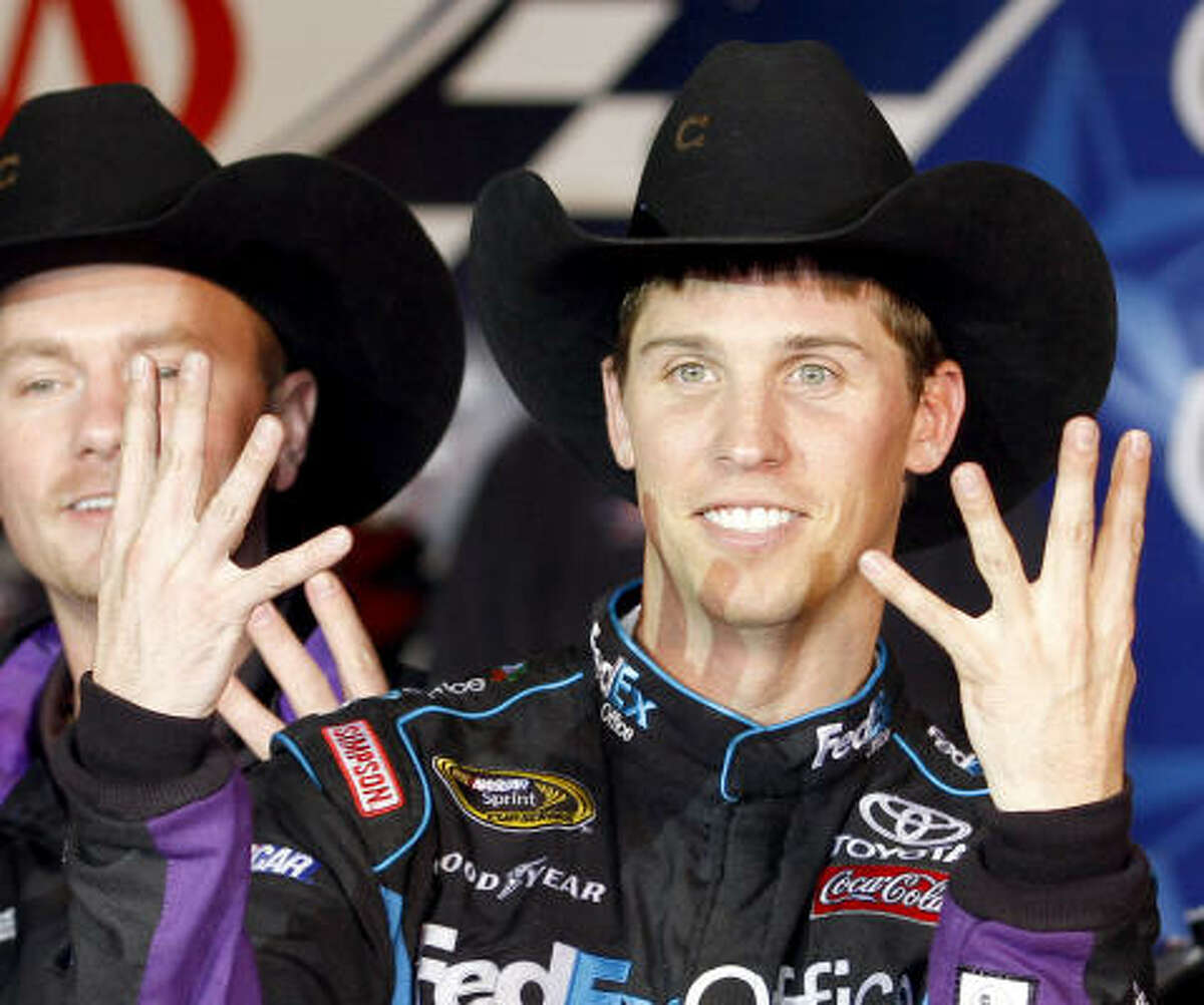 Denny Hamlin holds up eight fingers after his eighth win of the season.