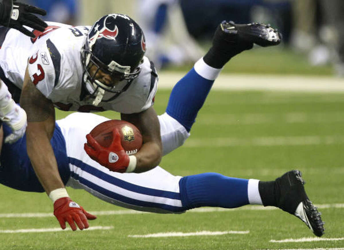 Texans running back Arian Foster (23) dives for extra yardage. He finished the game with 102 yards and one touchdown.
