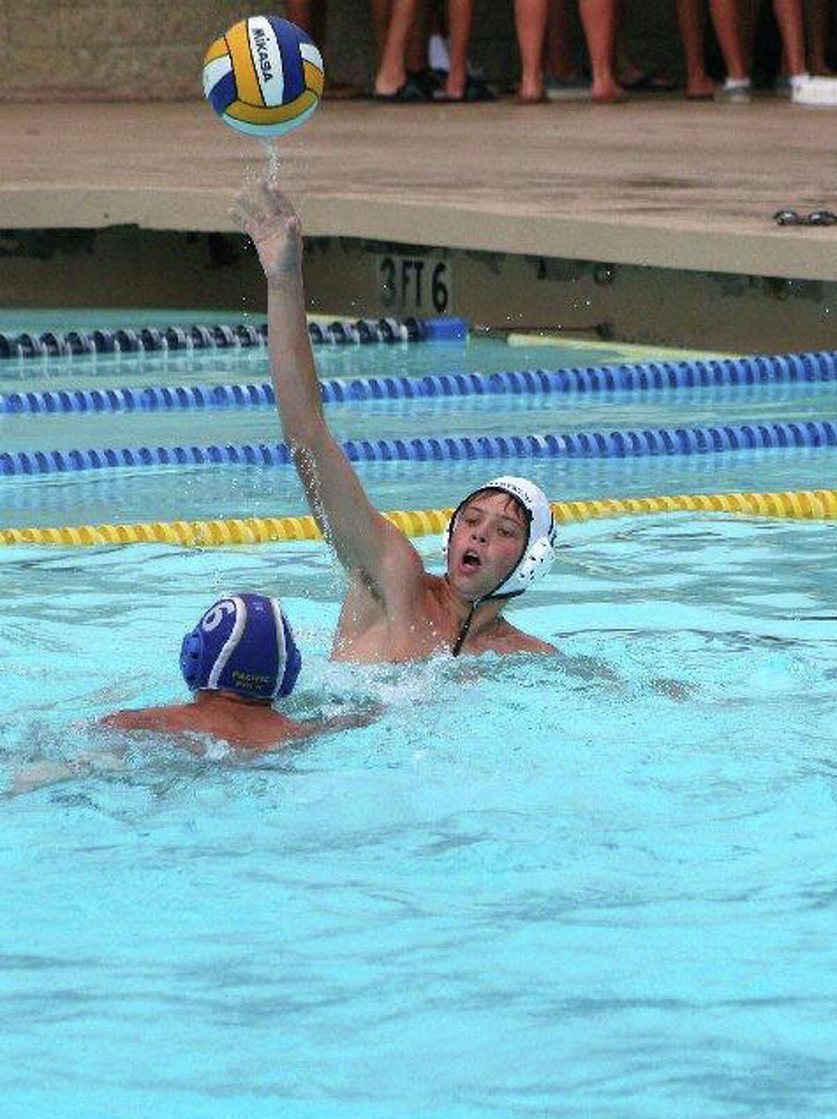 Greenwich Water Polo's Ben Wurst, one of the top scorers on the GWP U14 team makes a pass over a defender Wednesday in California. The U14 teams compiled a 4-4 record while playing in the Platinum Division of the 48 team tournament, placing 18th overall.