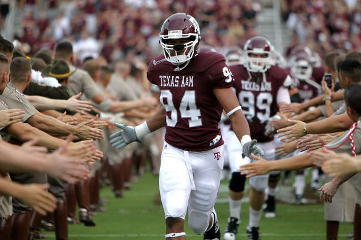 Texas A&M defensive tackle Damontre Moore (94) enters the field at the start of Saturday's game.