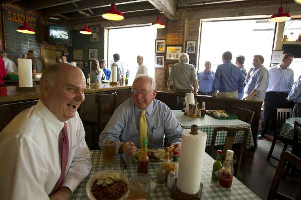 Financial advisors Jim Marsh, 65, and Tom Donovan, 65, share a laugh at Sammy's Bar-B-Q, a hot spot for business men and women in downtown Dallas. Donovan, a conservative, believes the influx of people moving to the Dallas area from out of state has giving the democratic party a boost.