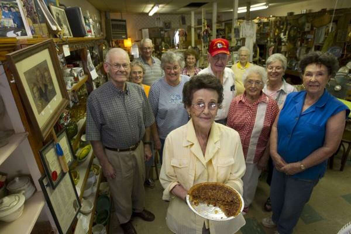 Maxine Herttenberger, 86, stands with her husband, Malcolm and a group of her friends, who are all older than 70, that meet at least once a week for a pot-luck-lunch in her antique store, which is one of the only buisnesses left in the town of Rule Tuesday, Aug. 31, 2010. The Herttenberger's say their community is not the same as it was and has lost some of its charm, as people left the community to find work. In the 1960's more than 1,300 people lived in Rule, today there are less than 600 people in the community. About 25 percent of Haskell County's residents are 65 and older compared to the rest of the state where 10 percent of the residents statewide are 65 and older.
