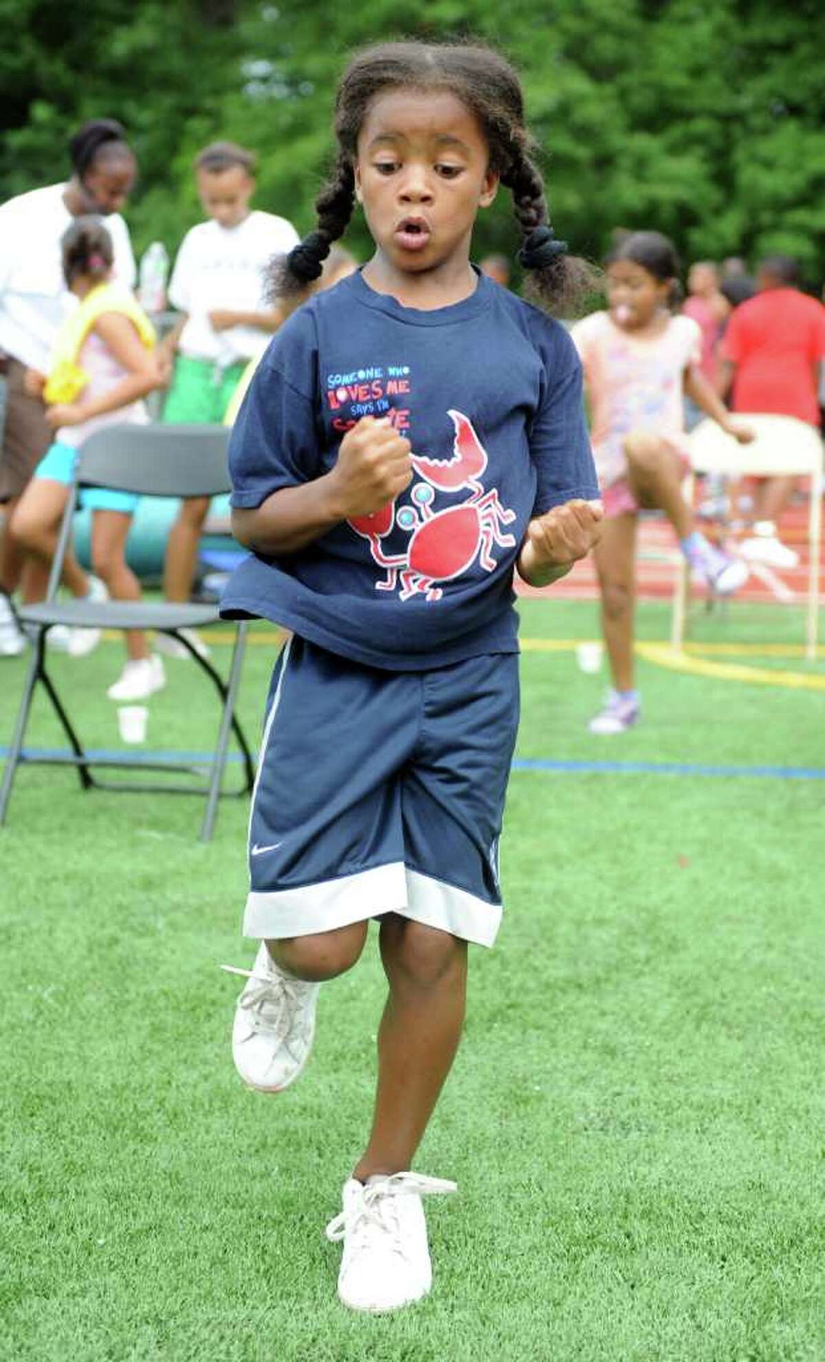 Nine-year-old Carsyn Langhorn, of Norwalk, jogs in place during the Chelsea Cohen Fitness Academy's 1st Annual Jamboree Wednesday, August 3, 2011 at Norwalk Highís Testa Field.