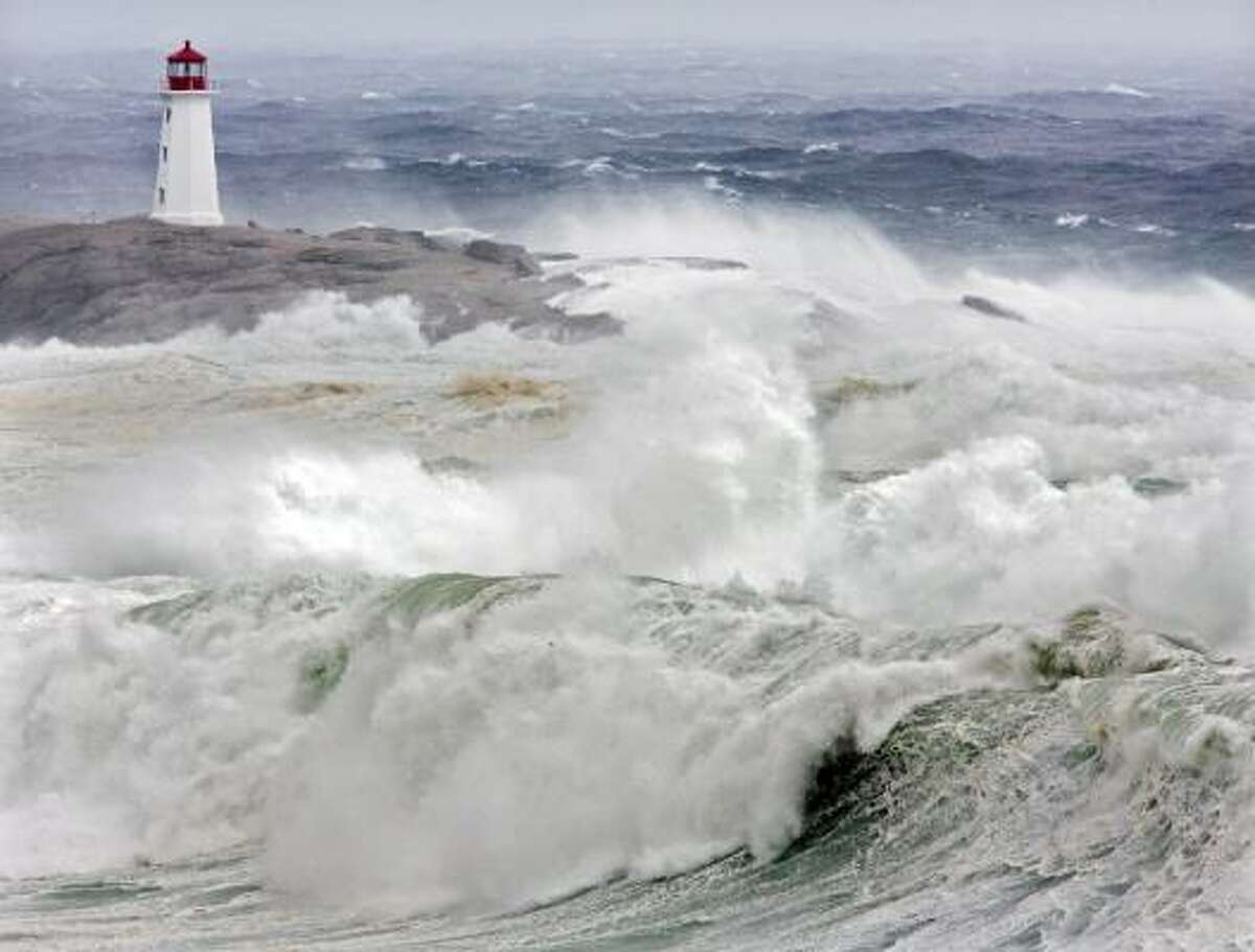 Waves from hurricane Earl pound the coast at Peggys Cove, Nova Scotia, Saturday, Sept. 4, 2010. Police closed roads leading to the iconic lighthouse as a safety precaution, keeping the curious away from the dangerous rocks. Heavy rain, high winds and surf battered the region.